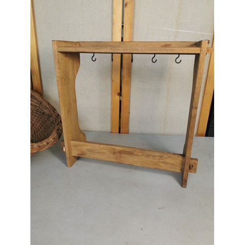 455 - A good quality vintage le Creuset solid beech pan rack along with a shaped wicker log basket. Both i... 