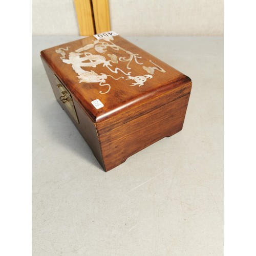 480 - An ornate solid mahogany oriental box featuring an inlaid mother of pearl dragon design to the top a... 