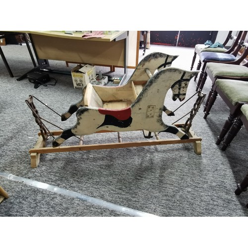 532 - A good quality very old antique double sided rocking horse with a seat to the middle on a wooden and... 