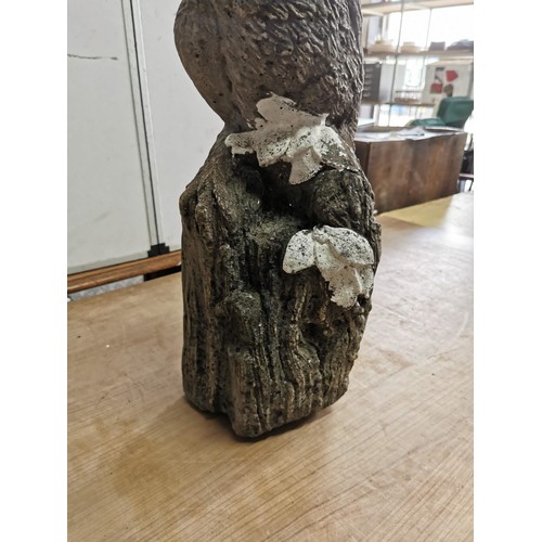 437 - Tall concrete ornament of an Owl standing on a wooden log in weathered condition stands at 54cm high