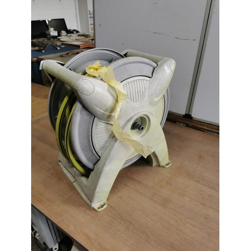 448 - Hose reel in carrier in good order with wall mount in good order