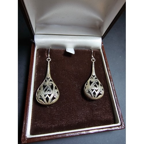 251 - A pair of ornate 925 silver long drop earrings with an intricate pierced design. Length of the drop ... 