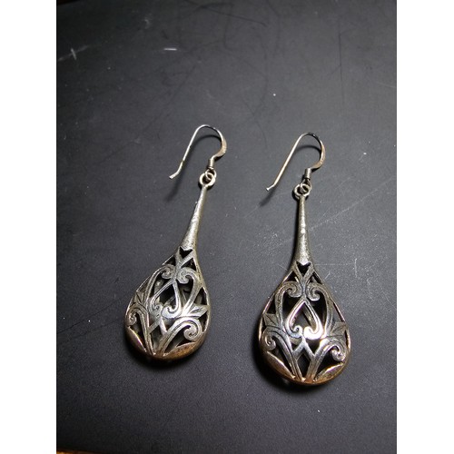 251 - A pair of ornate 925 silver long drop earrings with an intricate pierced design. Length of the drop ... 