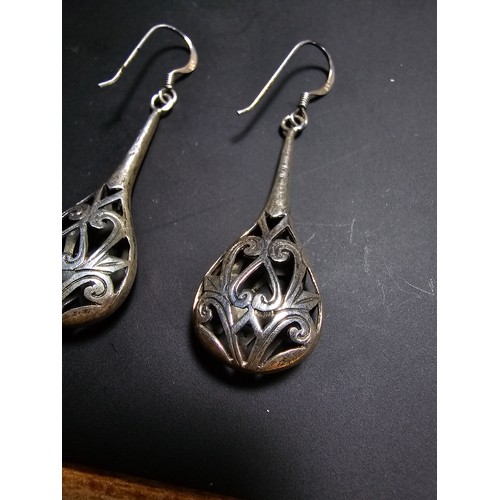 251 - A pair of ornate 925 silver long drop earrings with an intricate pierced design. Length of the drop ... 