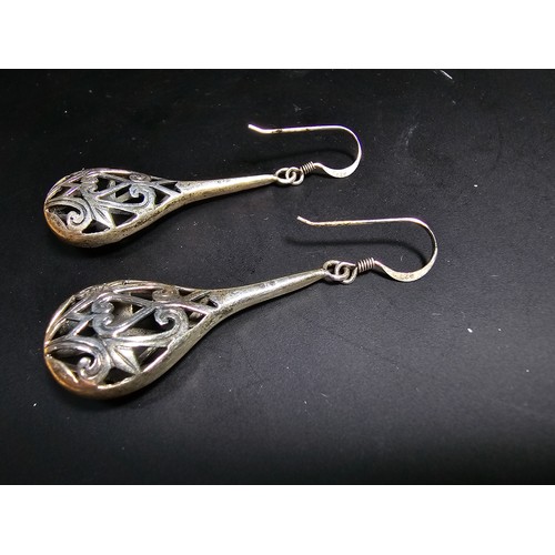 251 - A pair of ornate 925 silver long drop earrings with an intricate pierced design. Length of the drop ... 