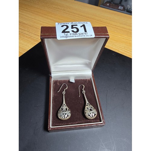 251 - A pair of ornate 925 silver long drop earrings with an intricate pierced design. Length of the drop ... 