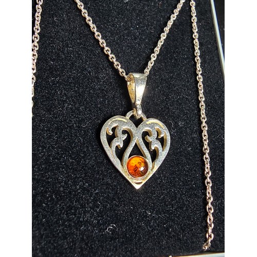 249 - An unused 925 silver pretty heart formed pendant inset with a genuine amber stone on an 18