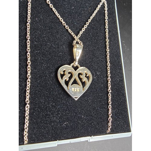 249 - An unused 925 silver pretty heart formed pendant inset with a genuine amber stone on an 18