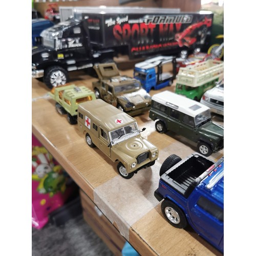 15 - A selection of diecast vehicles to include 2 large model scale trucks, sports cars, military vehicle... 