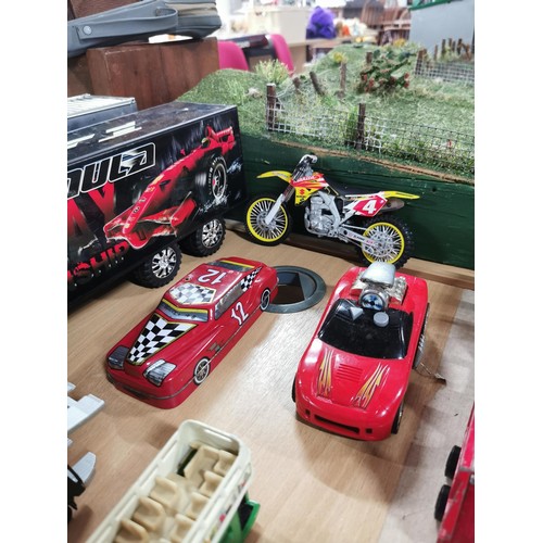 15 - A selection of diecast vehicles to include 2 large model scale trucks, sports cars, military vehicle... 