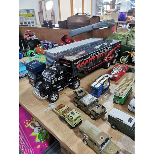 15 - A selection of diecast vehicles to include 2 large model scale trucks, sports cars, military vehicle... 