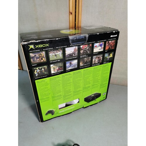 17 - A boxed original Xbox games console along with a Logic3 controller and includes cables. In excellent... 