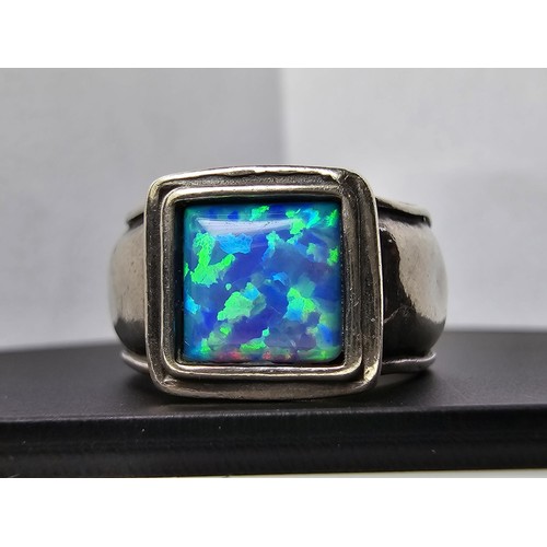 297 - A good vintage arts and crafts handmade sterling silver blue opal ring inset with a large cushion cu... 