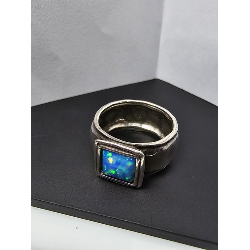 297 - A good vintage arts and crafts handmade sterling silver blue opal ring inset with a large cushion cu... 