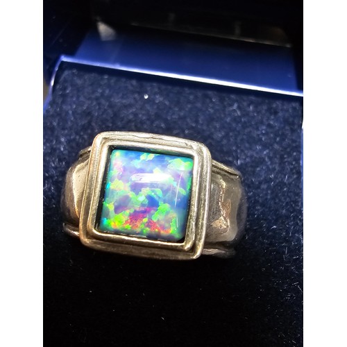 297 - A good vintage arts and crafts handmade sterling silver blue opal ring inset with a large cushion cu... 