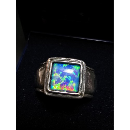 297 - A good vintage arts and crafts handmade sterling silver blue opal ring inset with a large cushion cu... 