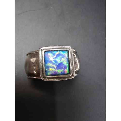 297 - A good vintage arts and crafts handmade sterling silver blue opal ring inset with a large cushion cu... 