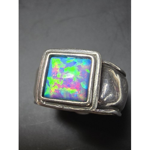 297 - A good vintage arts and crafts handmade sterling silver blue opal ring inset with a large cushion cu... 