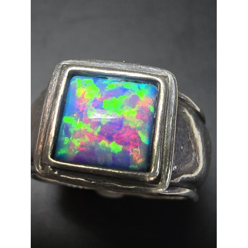 297 - A good vintage arts and crafts handmade sterling silver blue opal ring inset with a large cushion cu... 