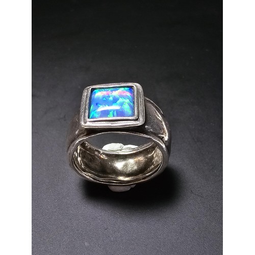 297 - A good vintage arts and crafts handmade sterling silver blue opal ring inset with a large cushion cu... 