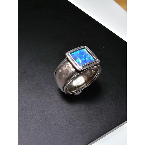 297 - A good vintage arts and crafts handmade sterling silver blue opal ring inset with a large cushion cu... 