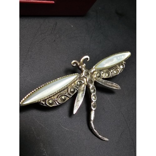 298 - A pretty vintage 925 silver may fly brooch inset with mother of pearl rings and marcasite stones, co... 