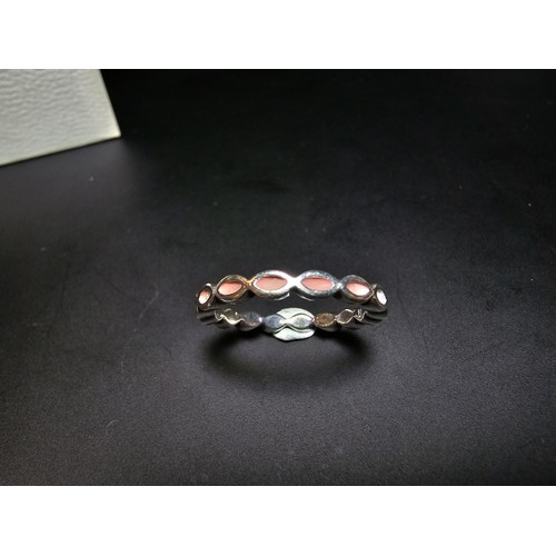 299 - A genuine Pandora ring with a pink enamel design all the way around, in good clean condition and com... 