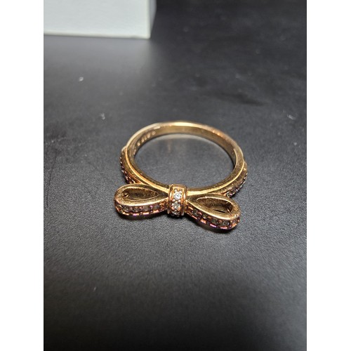 301 - A genuine Pandora as new unused rose gold ring with a bow design inset with clear crystals, marked A... 