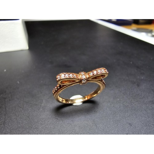 301 - A genuine Pandora as new unused rose gold ring with a bow design inset with clear crystals, marked A... 