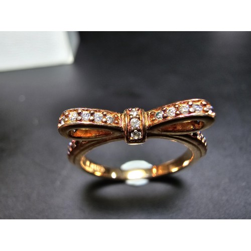 301 - A genuine Pandora as new unused rose gold ring with a bow design inset with clear crystals, marked A... 