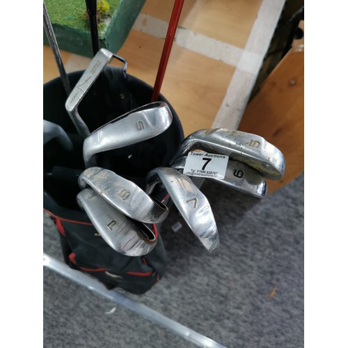 7 - A golf bag containing a quantity of gold clubs to include a 5, a 6, 2x 7's an 8, 2 sandwich and 1 pi... 