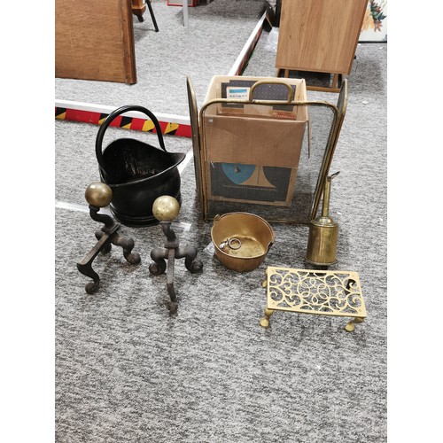 64 - A pair of antique fire dogs with brass balls atop, along with various fireside items, a trivet, bras... 