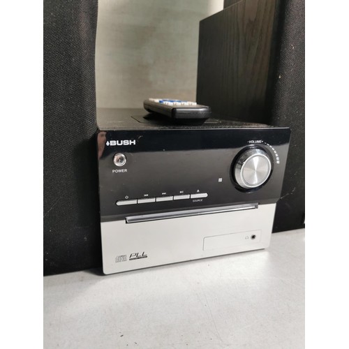 86 - A Bush mini hifi system model CMC1I, complete with speakers, CD, radio and charging dock along with ... 
