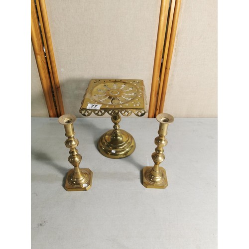 77 - Pair of good quality brass candle sticks along with a Victorian brass pedestal trivet / plant stand ... 