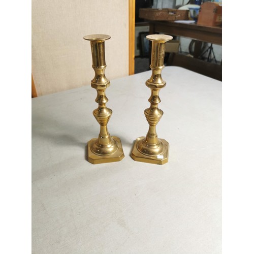 77 - Pair of good quality brass candle sticks along with a Victorian brass pedestal trivet / plant stand ... 