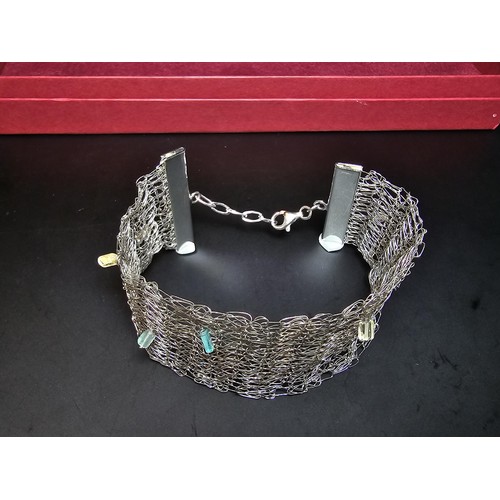 189 - An unusual 925 silver wide formed bracelet featuring an intricate wire-work design featuring crystal... 