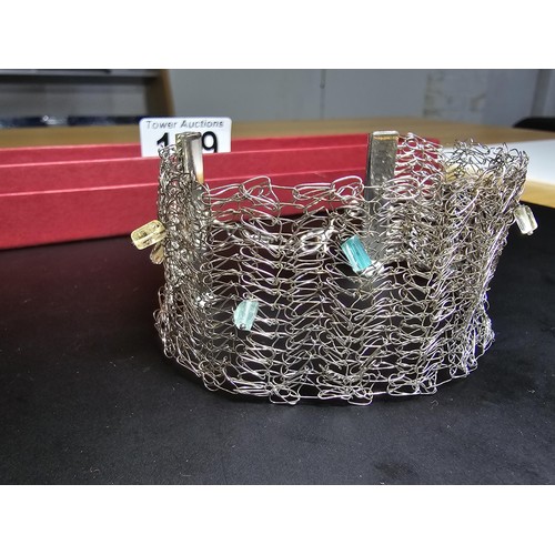 189 - An unusual 925 silver wide formed bracelet featuring an intricate wire-work design featuring crystal... 