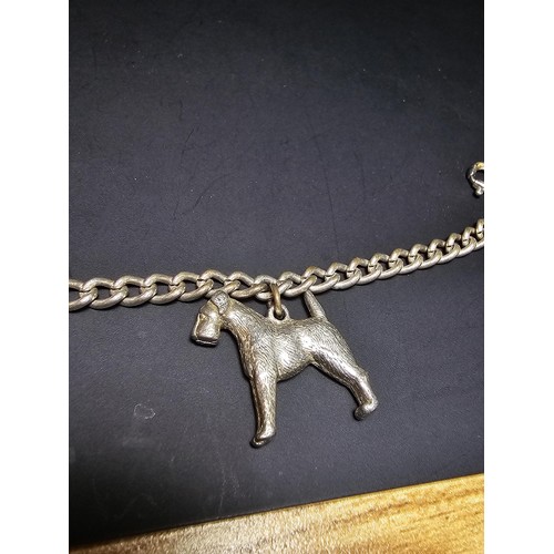 195 - An unusual silver plated charm bracelet featuring 4x well cast silver plated dog charms, each dog ch... 