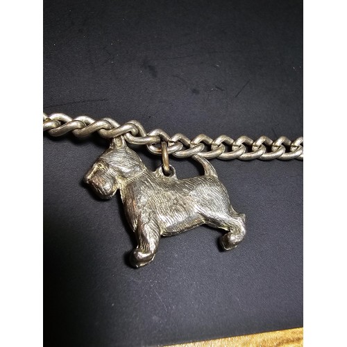 195 - An unusual silver plated charm bracelet featuring 4x well cast silver plated dog charms, each dog ch... 