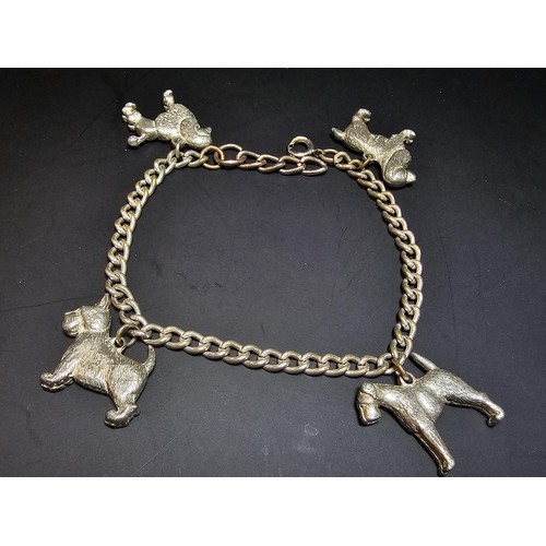 195 - An unusual silver plated charm bracelet featuring 4x well cast silver plated dog charms, each dog ch... 