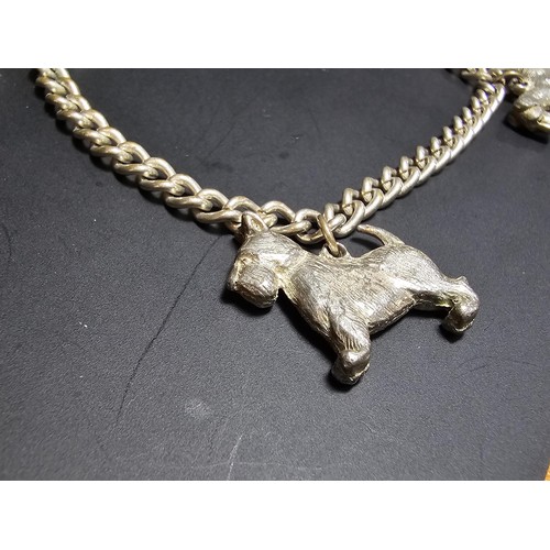 195 - An unusual silver plated charm bracelet featuring 4x well cast silver plated dog charms, each dog ch... 