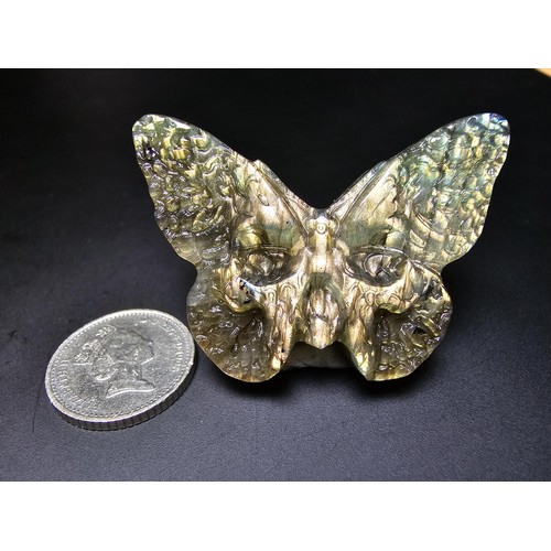 319 - A beautiful natural labradorite carved butterfly with a carved skull to the centre, presenting excel... 