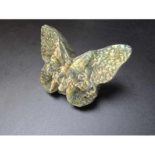 319 - A beautiful natural labradorite carved butterfly with a carved skull to the centre, presenting excel... 