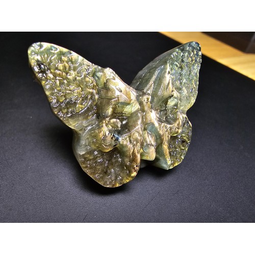 319 - A beautiful natural labradorite carved butterfly with a carved skull to the centre, presenting excel... 