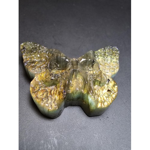 319 - A beautiful natural labradorite carved butterfly with a carved skull to the centre, presenting excel... 