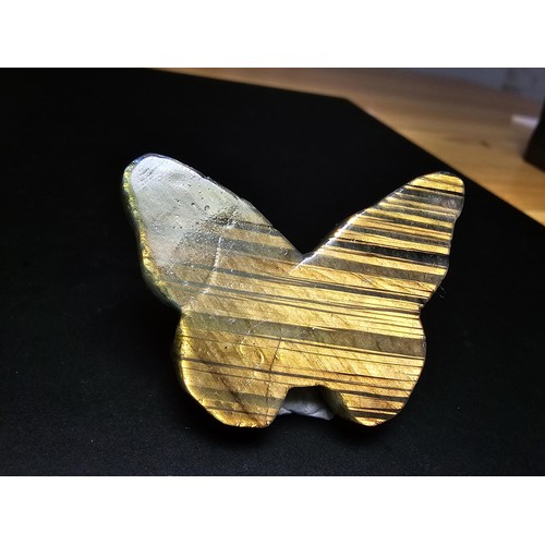 319 - A beautiful natural labradorite carved butterfly with a carved skull to the centre, presenting excel... 