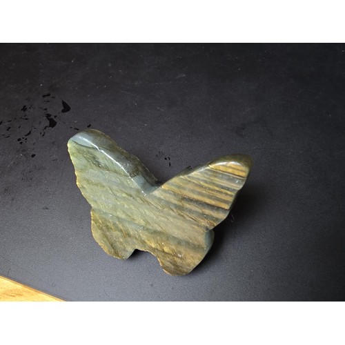 319 - A beautiful natural labradorite carved butterfly with a carved skull to the centre, presenting excel... 