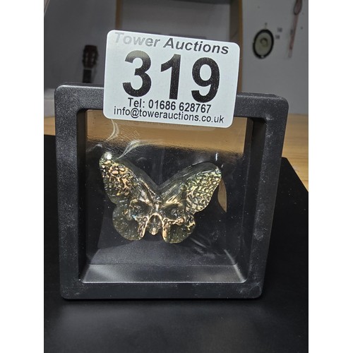 319 - A beautiful natural labradorite carved butterfly with a carved skull to the centre, presenting excel... 