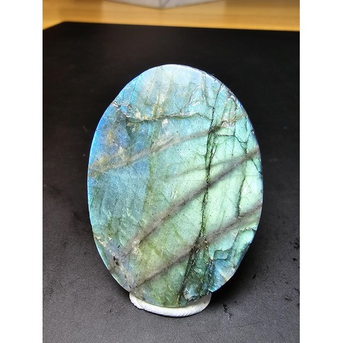 321 - A beautiful natural labradorite carved owl plaque presenting excellent natural flashing colours thro... 