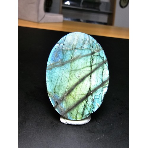 321 - A beautiful natural labradorite carved owl plaque presenting excellent natural flashing colours thro... 